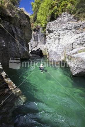 Female swims at Motatapu Gorge, Southern Lakes, South Island