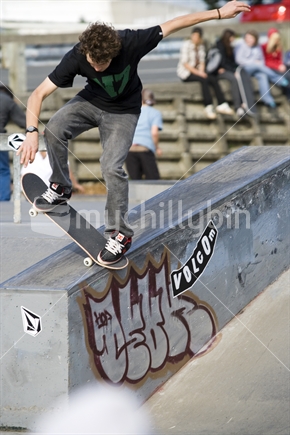 Skateboarder sliding ledge