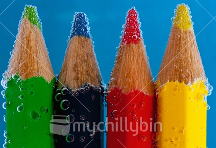 Coloured Pencils in soda water with bubbles
