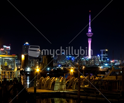 Auckland city at night, with dingys in the foreground