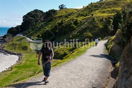 Walking around the base track of Mount Maunganui on a sunny day.
