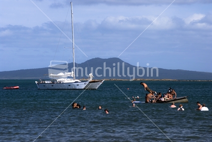 Yacht and swimmers with Rangitoto island in background