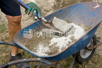 Mixing cement and sand in a wheelbarrow
