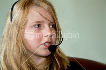 Young blonde woman using a headset