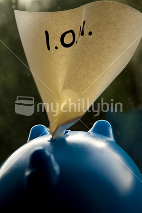 IOU note sticking out of a piggy bank