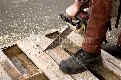 Chainsawing up a wooden pallet