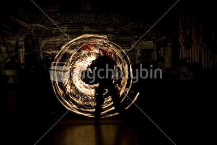 Swirls of fire from a fire juggling act