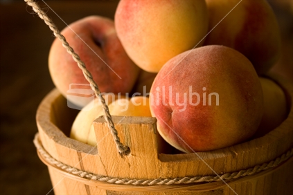 Peaches in a wooden bucket