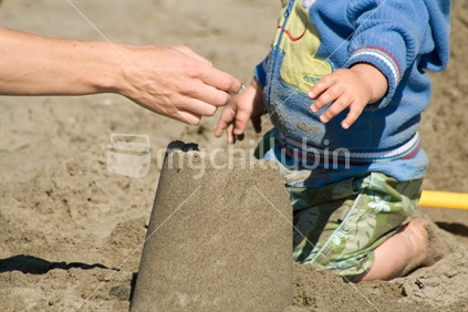 Building a sandcastle, New Zealand
