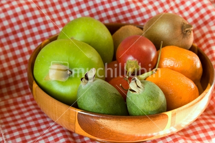 Wooden fruit bowl with assorted fruits