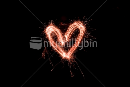 Red heart made with sparklers