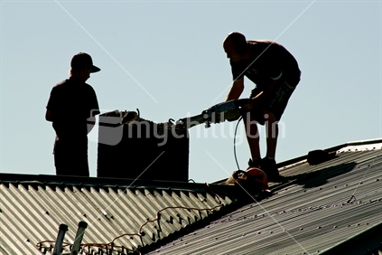 Workmen dismantle an earthquake damaged chimney  Christchurch, 2010. 