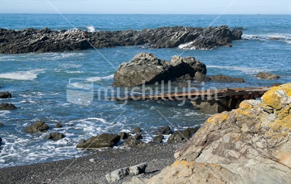 Rocky coastline with boat ramp; low tide