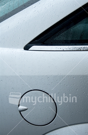 Portion of a wet car showing fuel flap