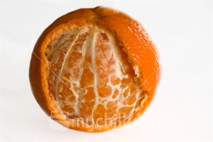 Mandarin, partly peeled, on white background