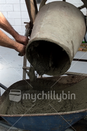 Wet concrete mix being tipped from a concrete mixer