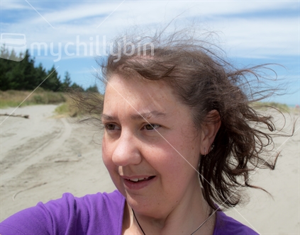Woman at the beach on a windy day 