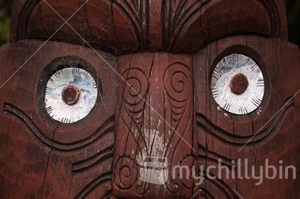 Close up of paua shell eyes on a Maori carving