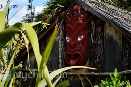 Maori carving on the side of a whare at Hamilton Gardens