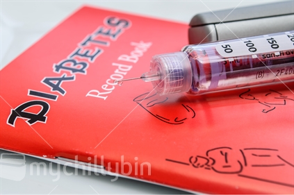 Diabetes book and insulin syringe