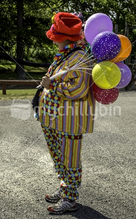 Colourful clown selling balloons (Quirky)  Sorry, I do not have a model release and do not know how I could get one, so editorial only