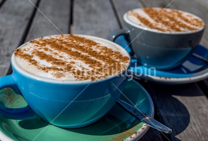 Two cappuccinos with cinnamon