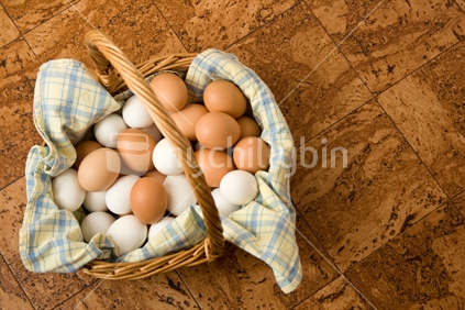Basket of eggs on cork background