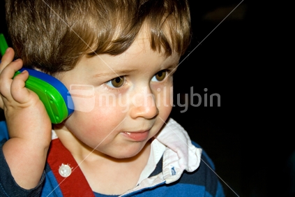 Boy listening on toy phone