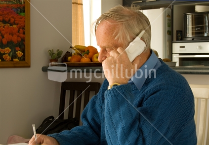 Older man talking on telephone