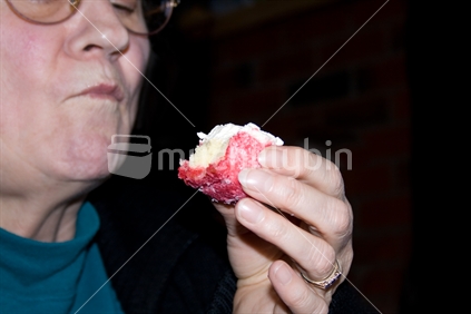 Woman eating a lamington