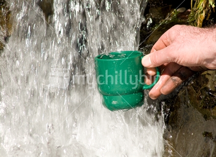 Filling a cup from a waterfall
