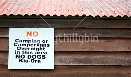 No Camping sign on side of shed
