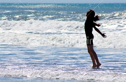 Girl playing in the waves
