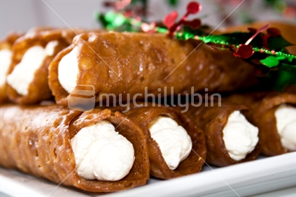 Stack of brandy snaps with Christmas garland
