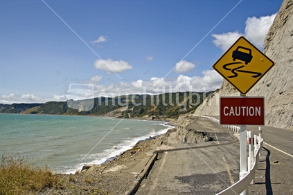 Warning road sign where road has slipped into the sea on Southern Wairarapa coast