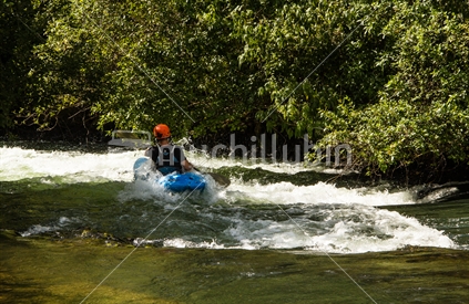 A kayak enters rapids on the Kaituna river