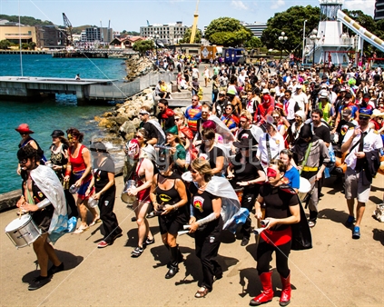 a crowd of rugby sevens followers parades along Wellington's waterfront