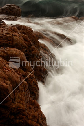 Incoming tide hits the rocks at Oriental Bay