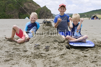 Three boys with their sand man