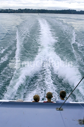 Three boys on the back of a ferry
 