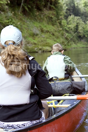 Two teenagers in Canadian Canoe on Whanganui River, New Zealand