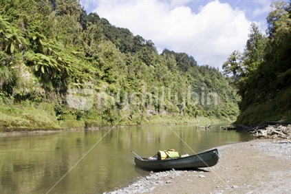Whanganui River and surrounding native bush with a canadian canoe, New Zealand