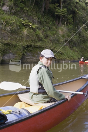Teenage boy in a canoe on Whanganui River, New Zealand