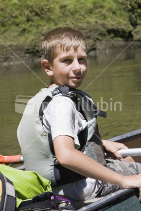 Teenage boy in a canoe, New Zealand