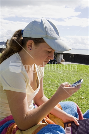 Teenage girl texting on a mobile phone