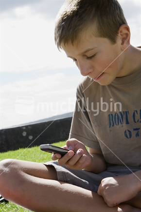 Teenage boy Texting on a mobile phone