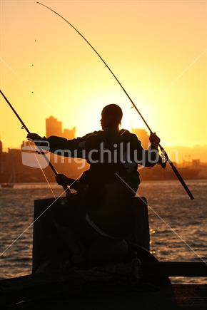 Fishing off Devonport wharf at sunset 