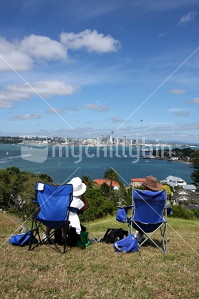Couple looking over the Auckland skyline from Devonport North Head 