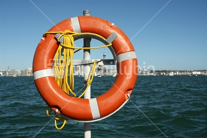 Life buoy in front of Auckland skyline 