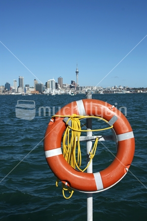 Life buoy in front of Auckland skyline 